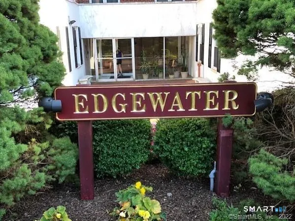 a sign broad in front of red brick house