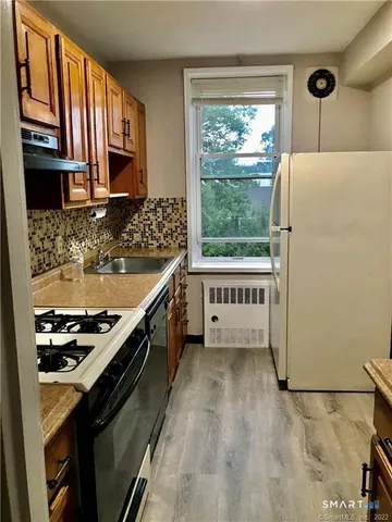 a kitchen with a stove a refrigerator and a stove