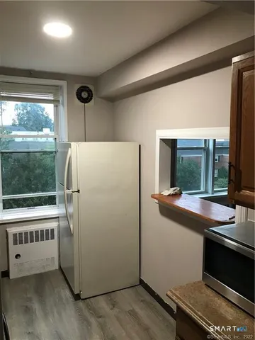 a kitchen with a refrigerator and a window