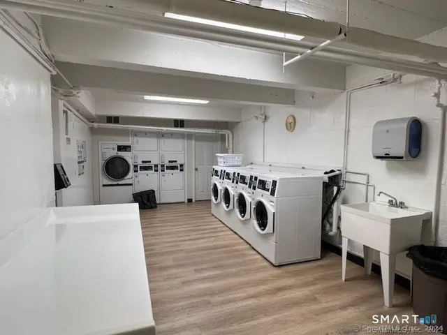 a view of a kitchen with furniture and wooden floor
