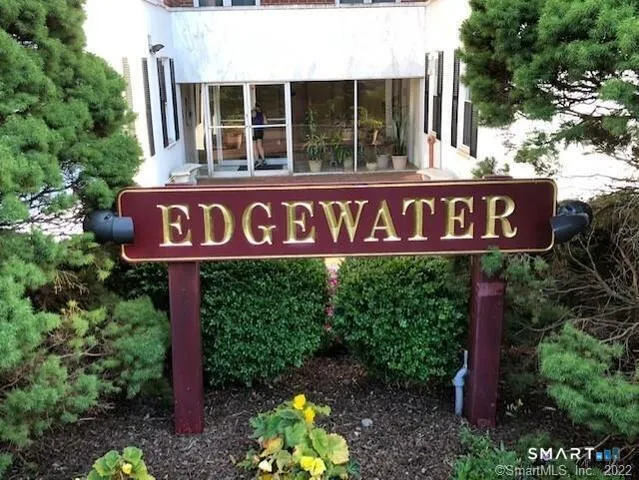 a sign broad in front of red brick house