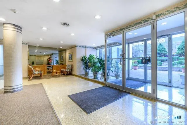 a view of a lobby with furniture and floor to ceiling window