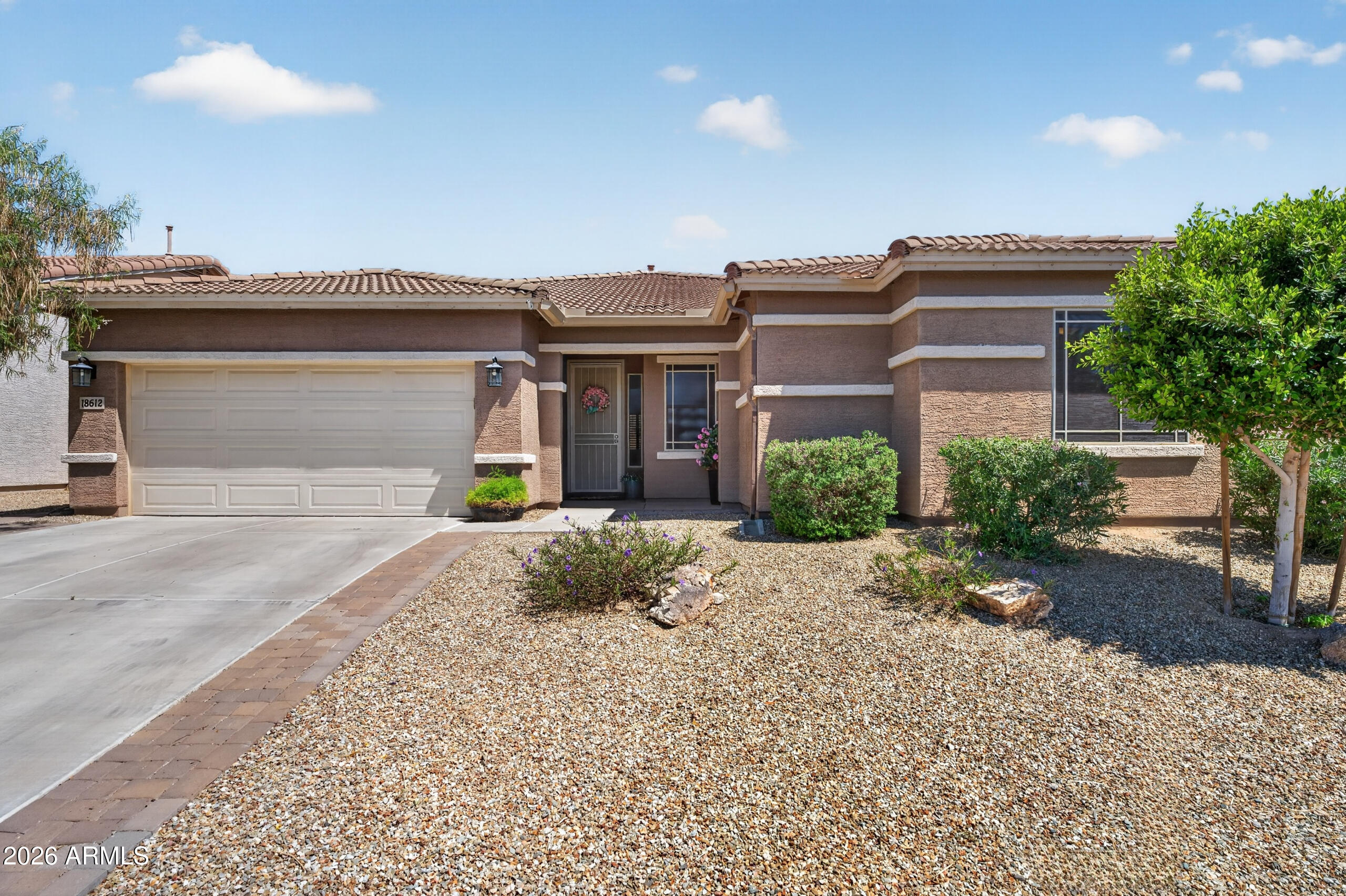 18612 West Mountain View Road Waddell, AZ 85355 - Photo 1 of 71 a front view of a house with garden