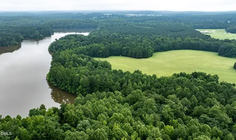an aerial view of ocean with green space
