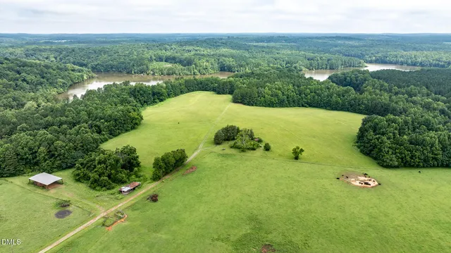 an aerial view of a house with a lake view