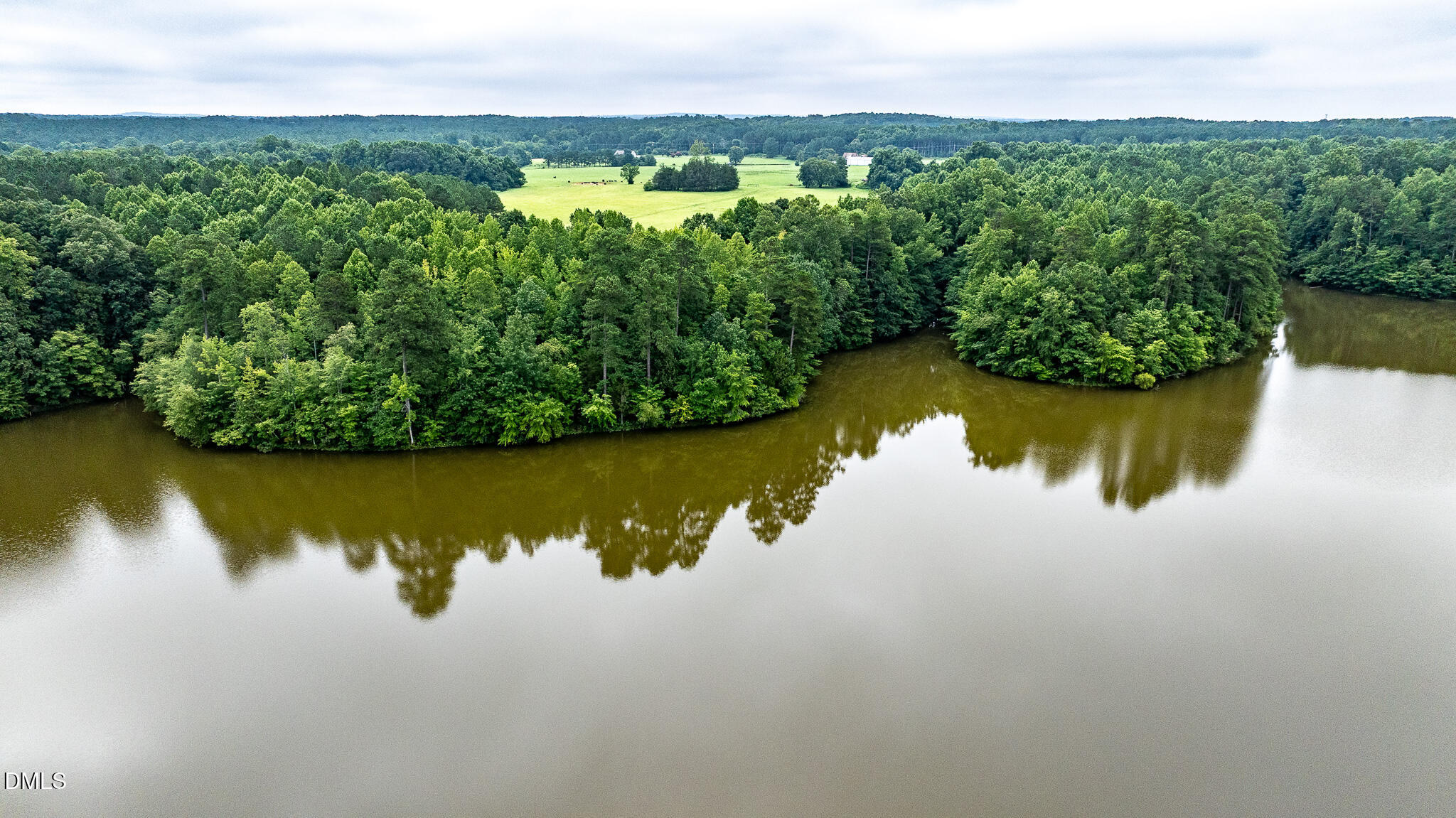 0 Teer Road Chapel Hill, NC 27516 - Photo 36 of 40 a view of a lake with a mountain in the background