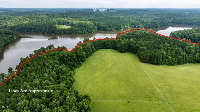 a view of a lake in middle of the green field