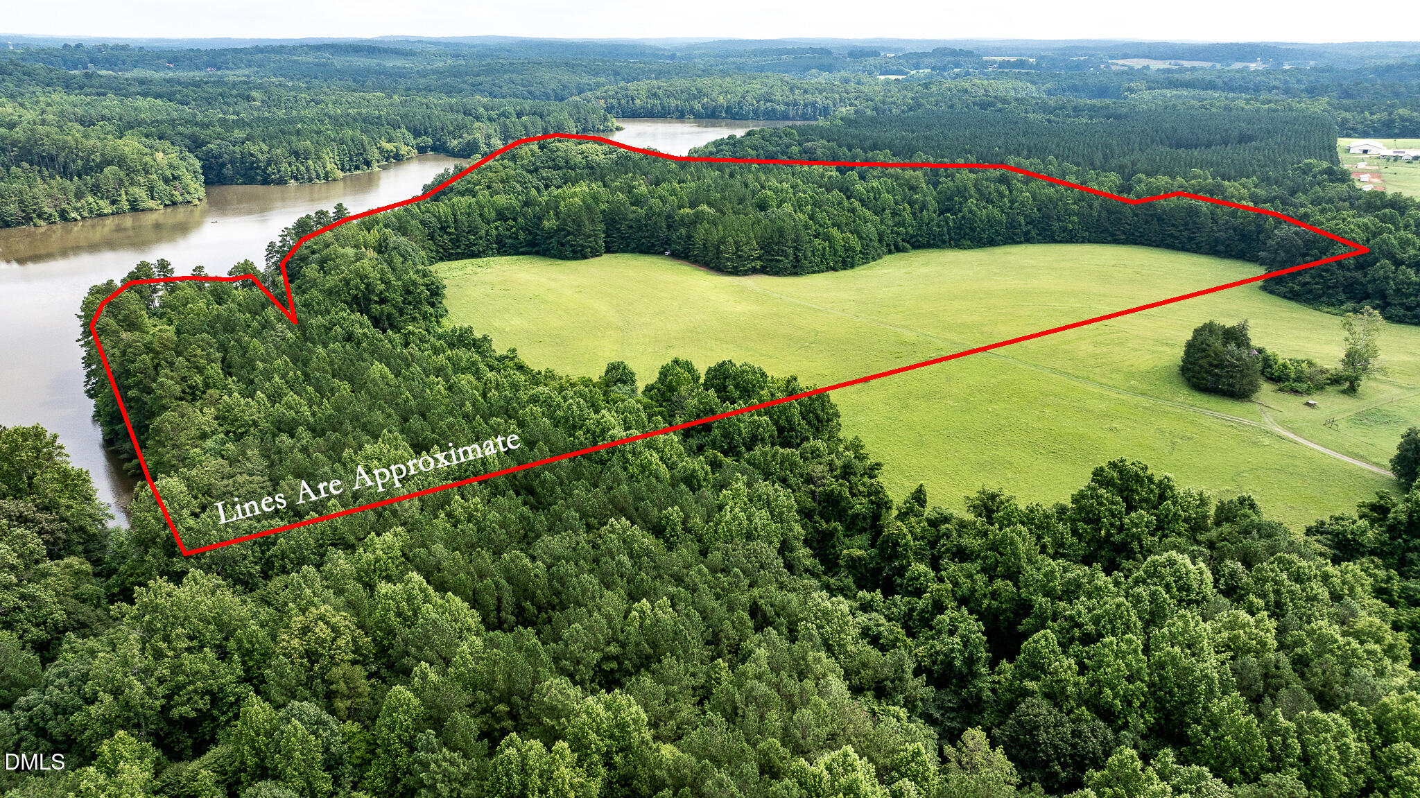 0 Teer Road Chapel Hill, NC 27516 - Photo 10 of 40 a view of a lake with a mountain and a yard