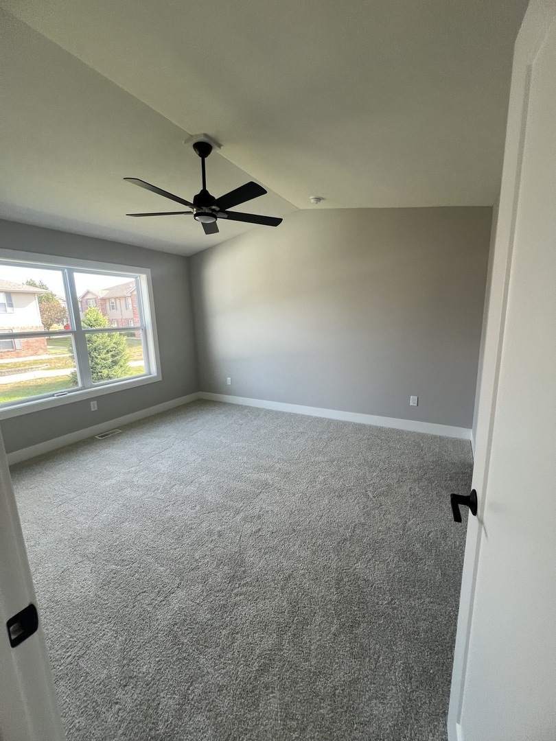 1732 Millstone Drive Normal, IL 61761 - Photo 2 of 11 an empty room with windows and ceiling fan