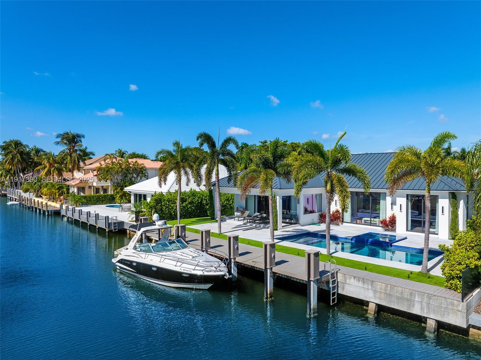 900 Washington Street Hollywood, FL 33019 - Photo 46 of 61 a view of a swimming pool with lawn chairs with plants