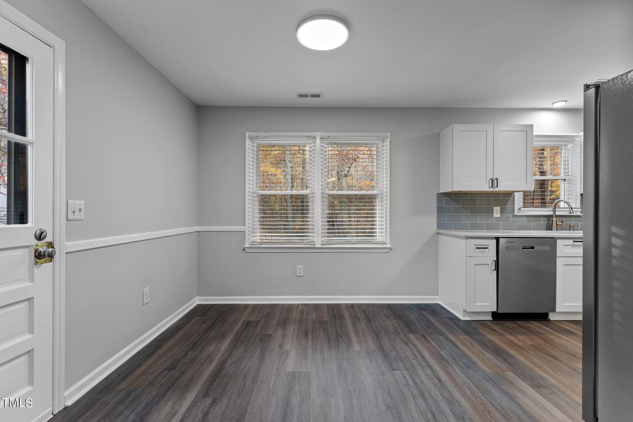 6415 Whitt Road Durham, NC 27712 - Photo 12 of 37 an empty room with wooden floor and a window