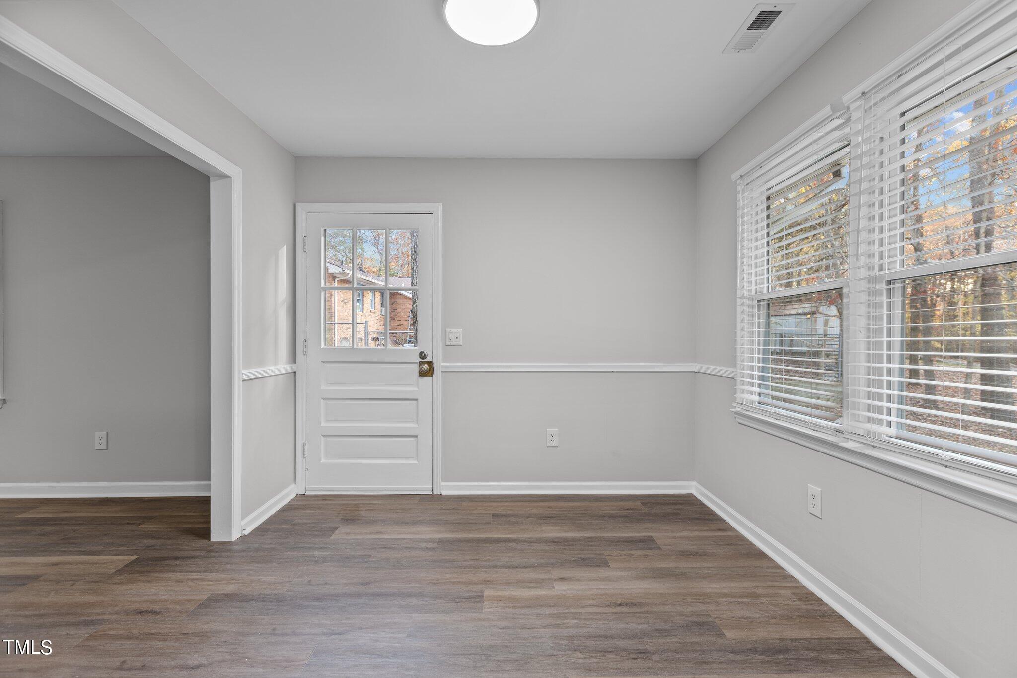 6415 Whitt Road Durham, NC 27712 - Photo 13 of 37 wooden floor in an empty room with a window