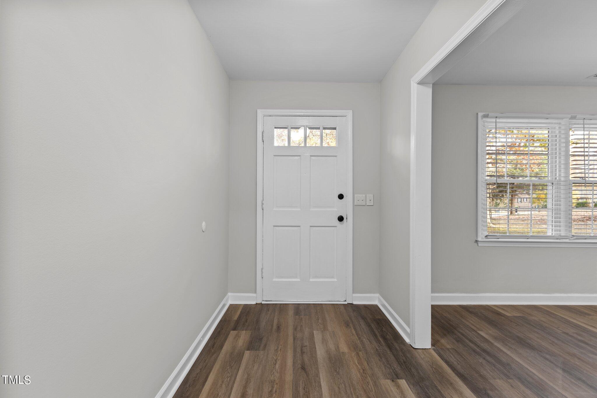 6415 Whitt Road Durham, NC 27712 - Photo 15 of 37 an empty room with wooden floor and windows