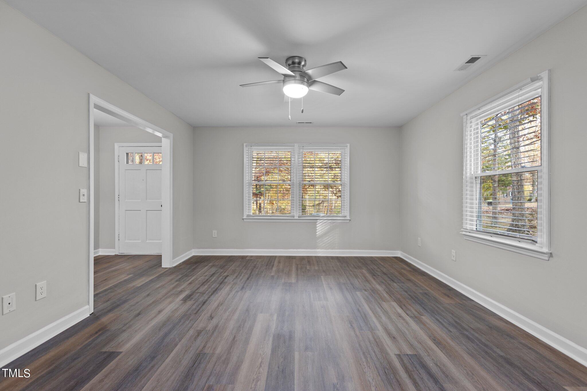 6415 Whitt Road Durham, NC 27712 - Photo 17 of 37 a view of an empty room with wooden floor and a window