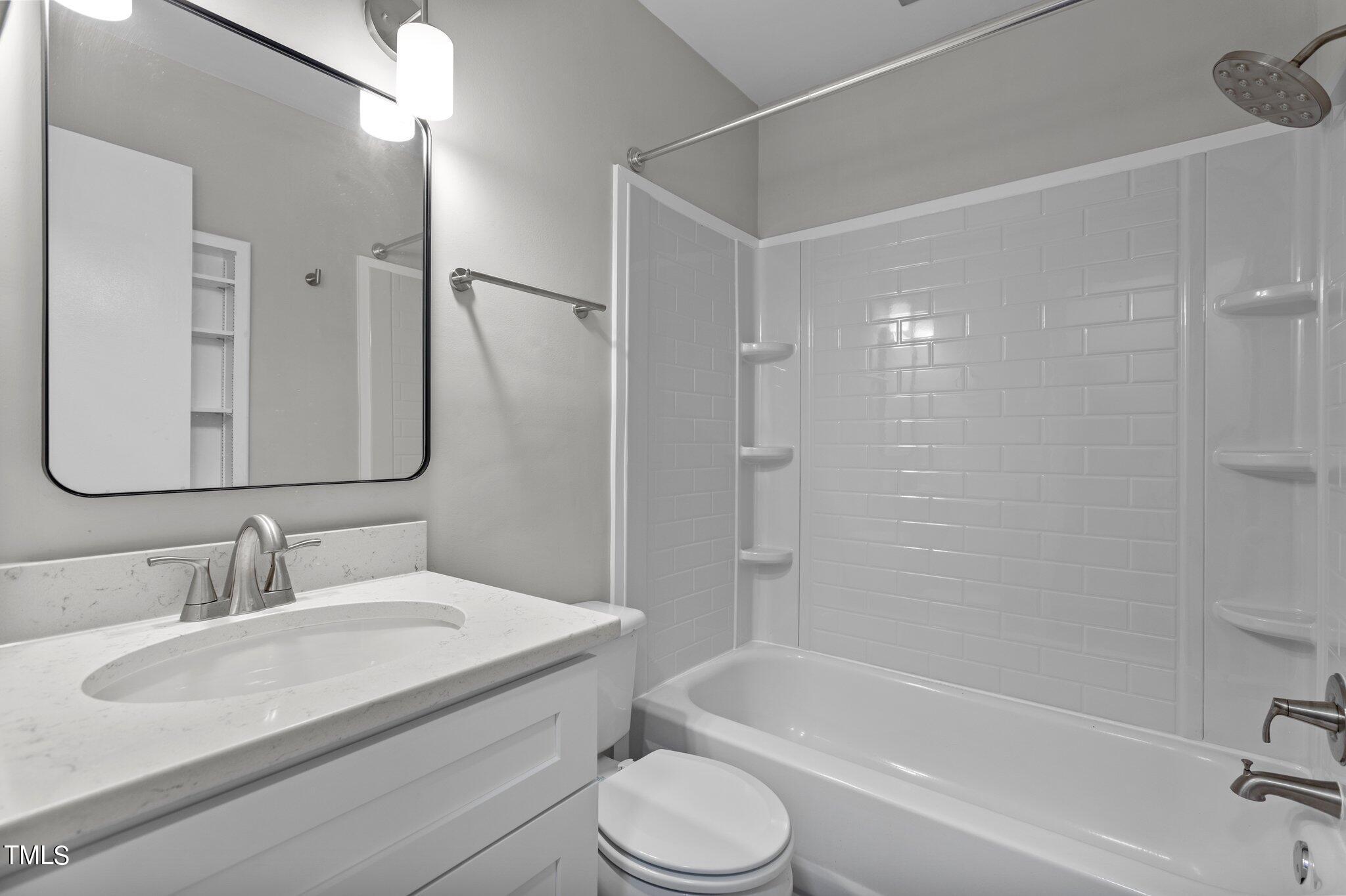 6415 Whitt Road Durham, NC 27712 - Photo 18 of 37 a bathroom with a granite countertop sink toilet and shower