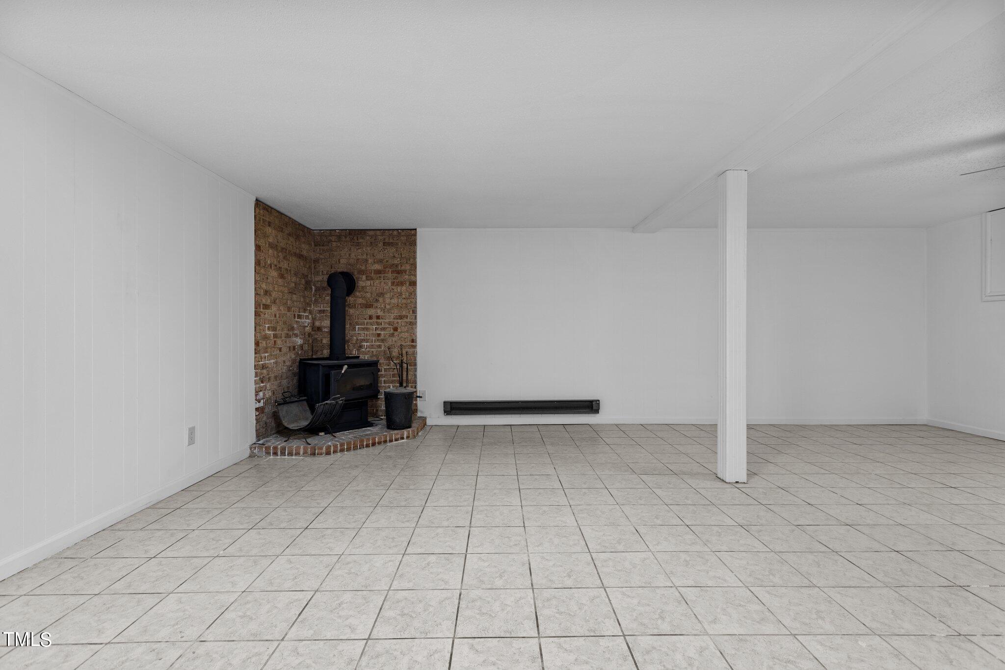 6415 Whitt Road Durham, NC 27712 - Photo 28 of 37 an empty room with fireplace