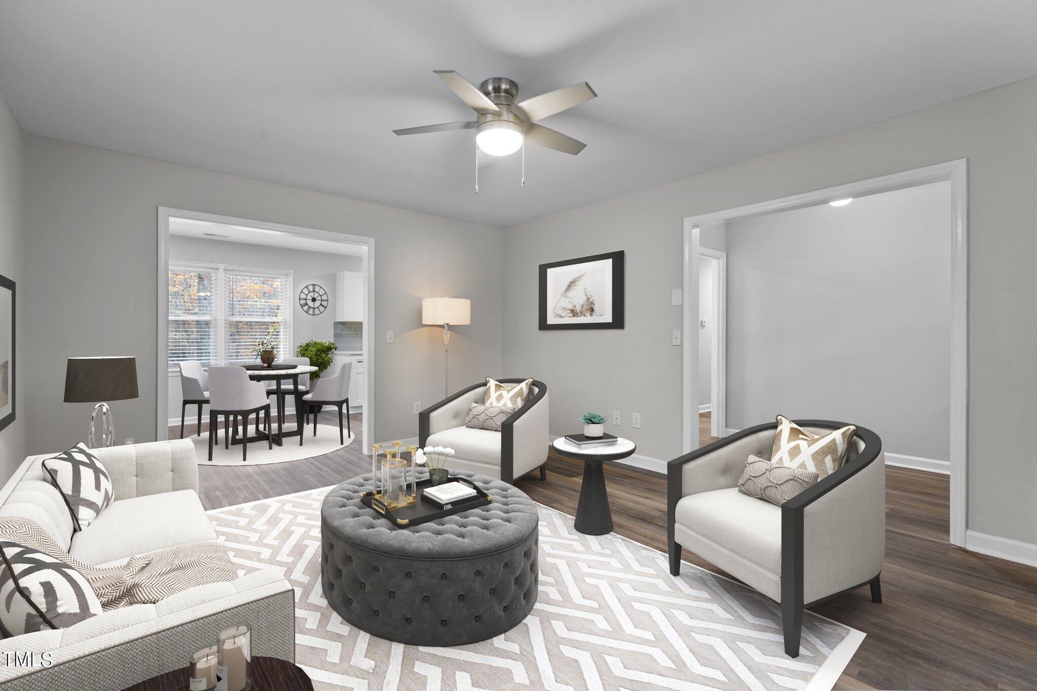 6415 Whitt Road Durham, NC 27712 - Photo 3 of 37 a living room with furniture and a chandelier