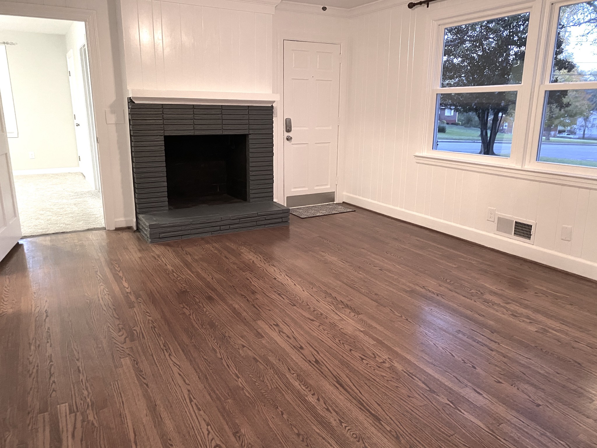 500 Vantrease Road Madison, TN 37115 - Photo 12 of 45 an empty room with wooden floor fireplace and windows