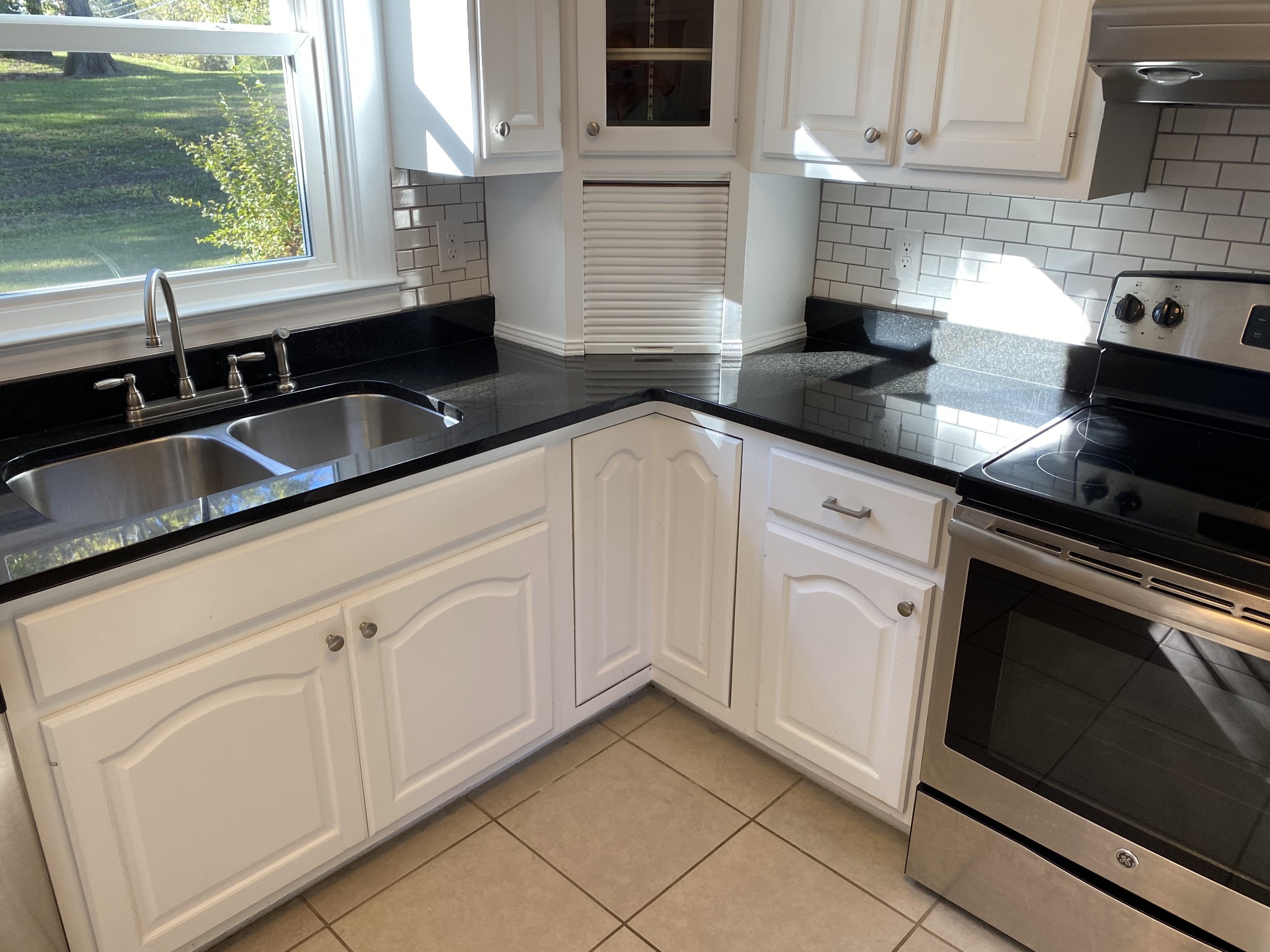500 Vantrease Road Madison, TN 37115 - Photo 16 of 45 a kitchen with white cabinets a sink and a stove