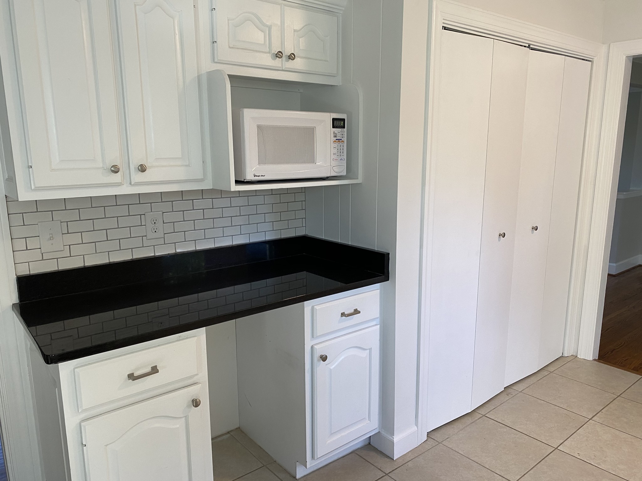 500 Vantrease Road Madison, TN 37115 - Photo 18 of 45 a kitchen with white cabinets and black appliances