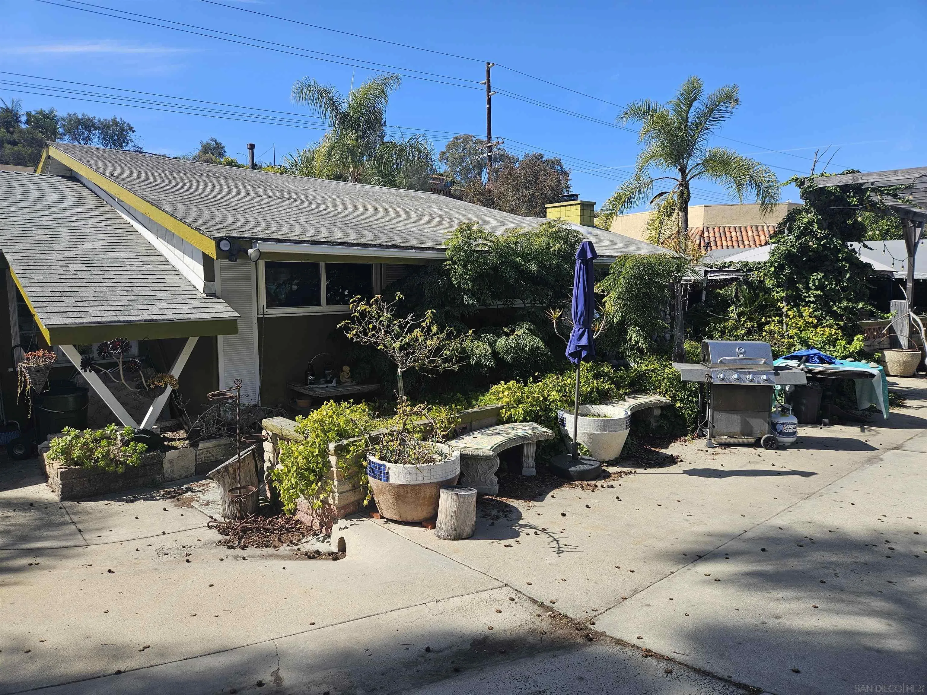 935 Encinitas Boulevard Encinitas, CA 92024 - Photo 4 of 8 a view of a patio with a table and chairs under an umbrella