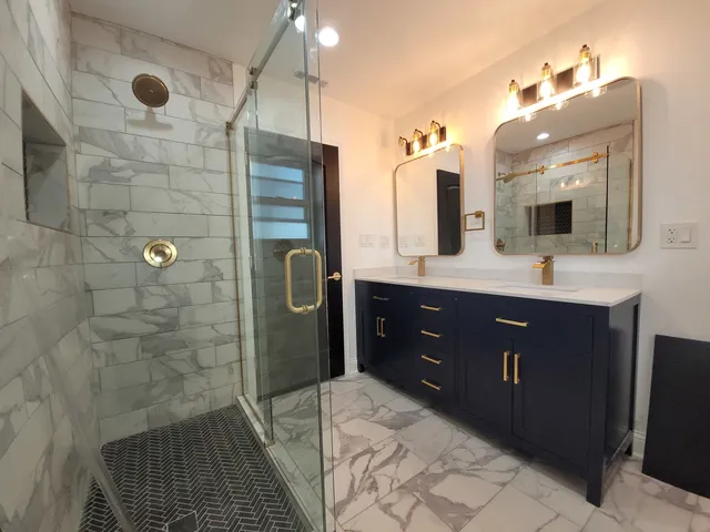 a bathroom with a sink a toilet a large mirror and shower