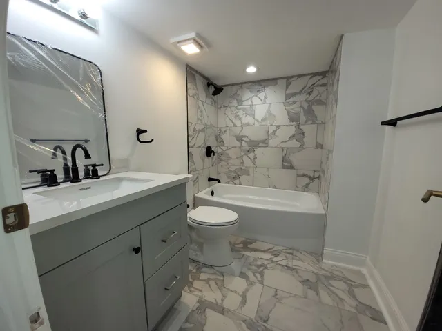 a bathroom with a toilet a sink and a bathtub