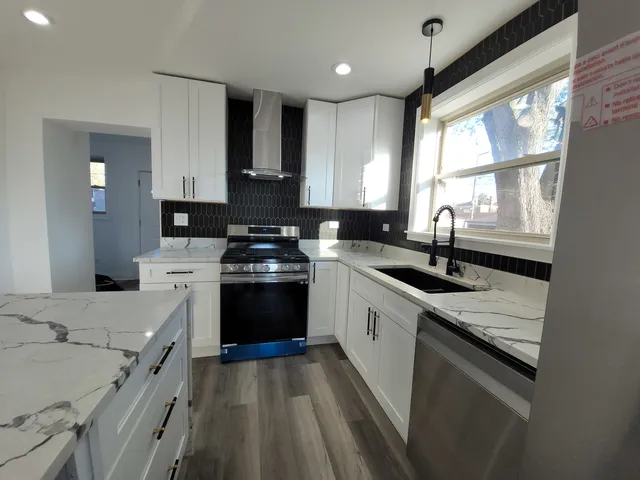 a kitchen with a sink stove top oven and cabinets