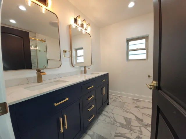 a bathroom with a double vanity sink a mirror and a