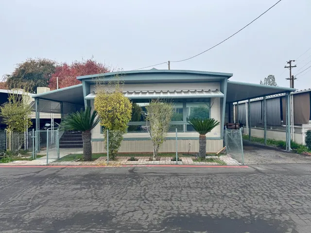 a view of a house with a porch and a table