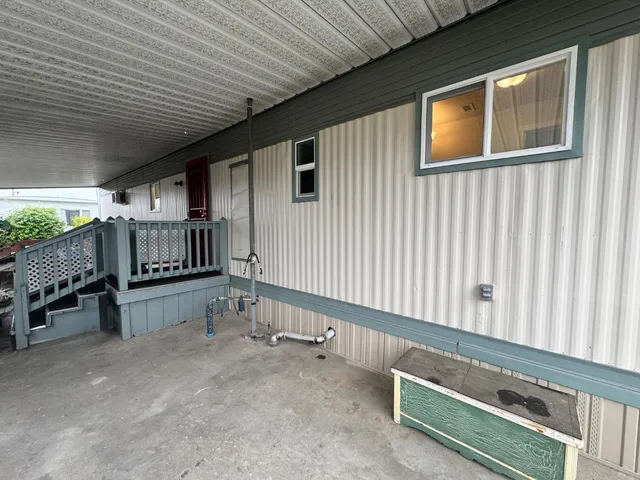 a view of a room with wooden walls and stairs