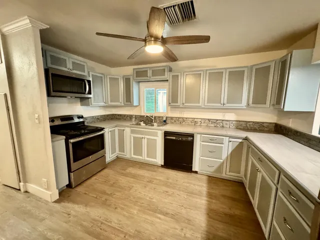 a kitchen with stainless steel appliances granite countertop a stove and a sink