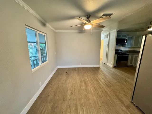 wooden floor in an empty room with a window