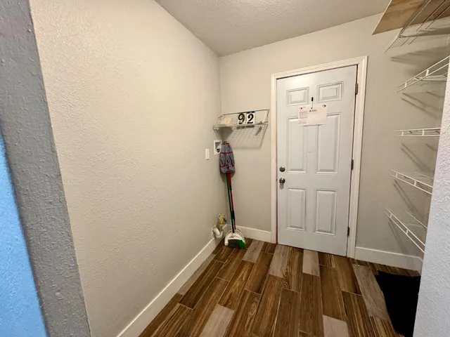 a view of a room with wooden floor and bathroom