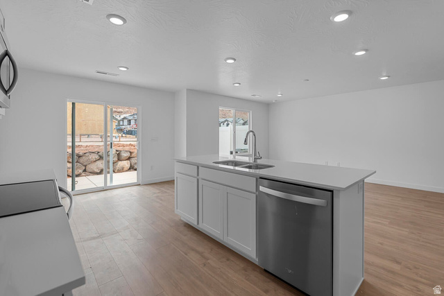2133 Wolverine Way, Unit 2440 Washington, UT 84780 - Photo 10 of 39 Open-concept kitchen featuring a central island with an undermount double-basin sink and stainless steel dishwasher
