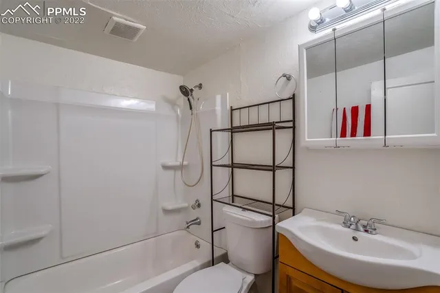 a view of storage and utility room with wooden floor