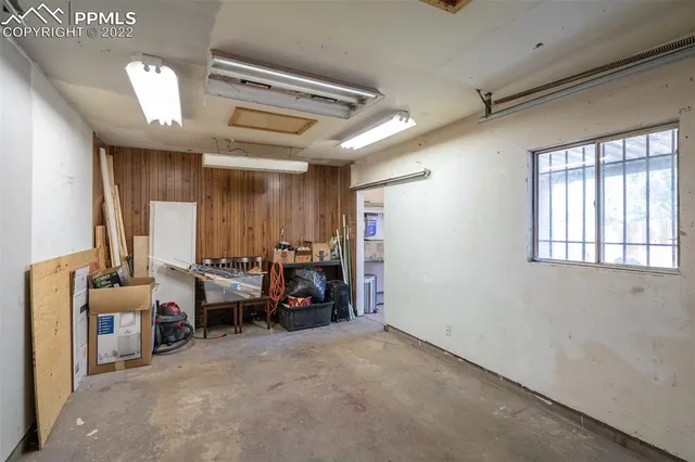 a view of backyard with wooden fence and a slide