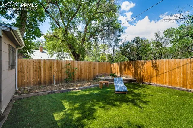 a view of backyard with a garden and deck