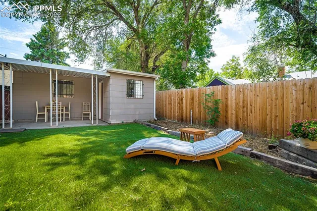 a dining room with a table and chairs and potted plants