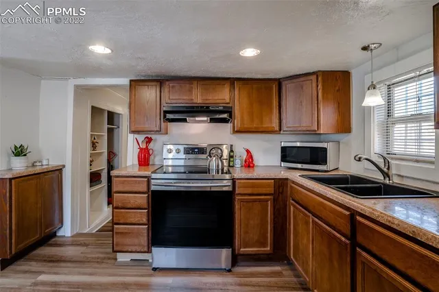 a kitchen with stainless steel appliances granite countertop a stove and cabinets