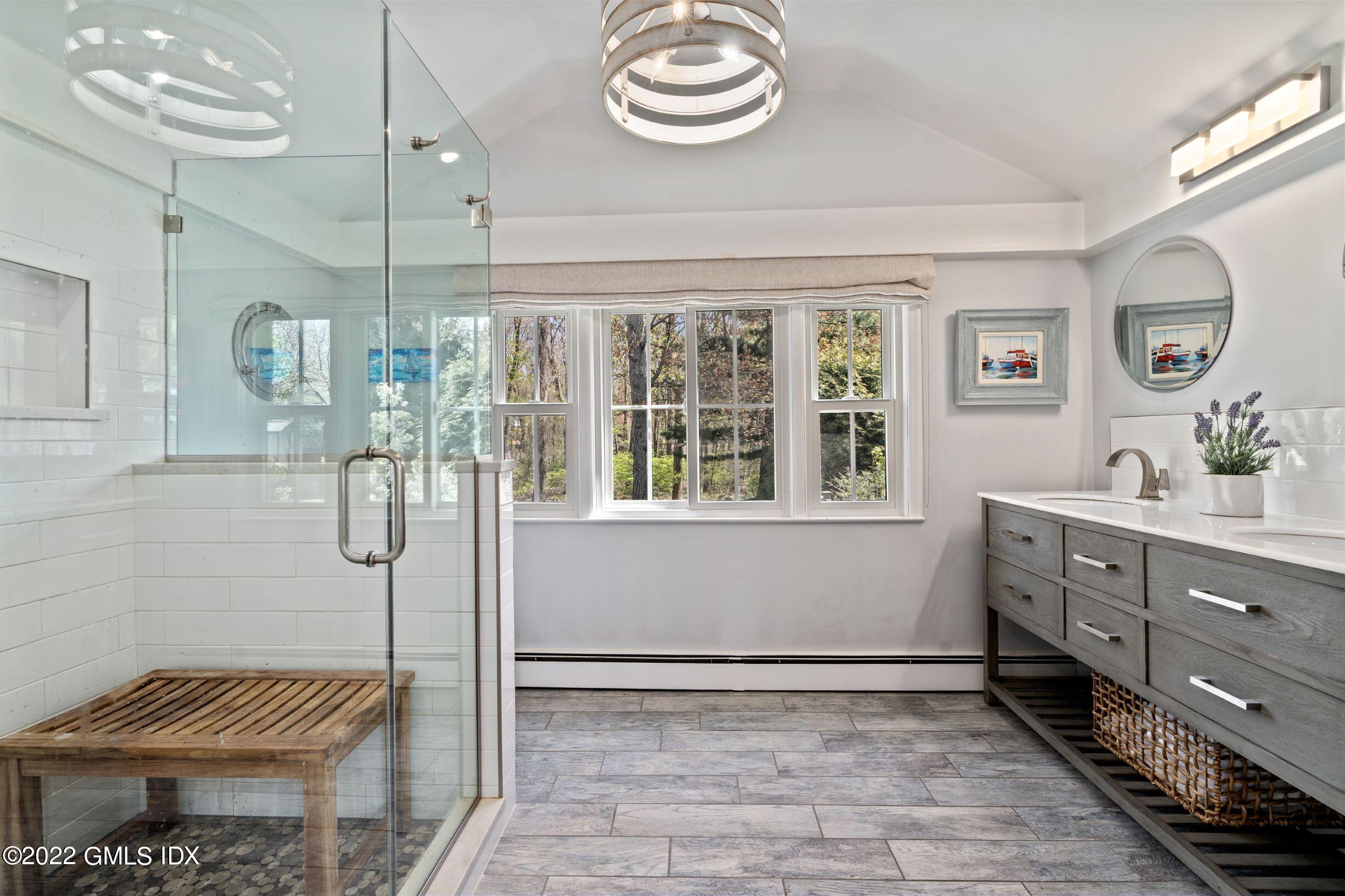 23 Manor Road Old Greenwich, CT 06870 - Photo 11 of 25 a bathroom with a sink a mirror and a shower