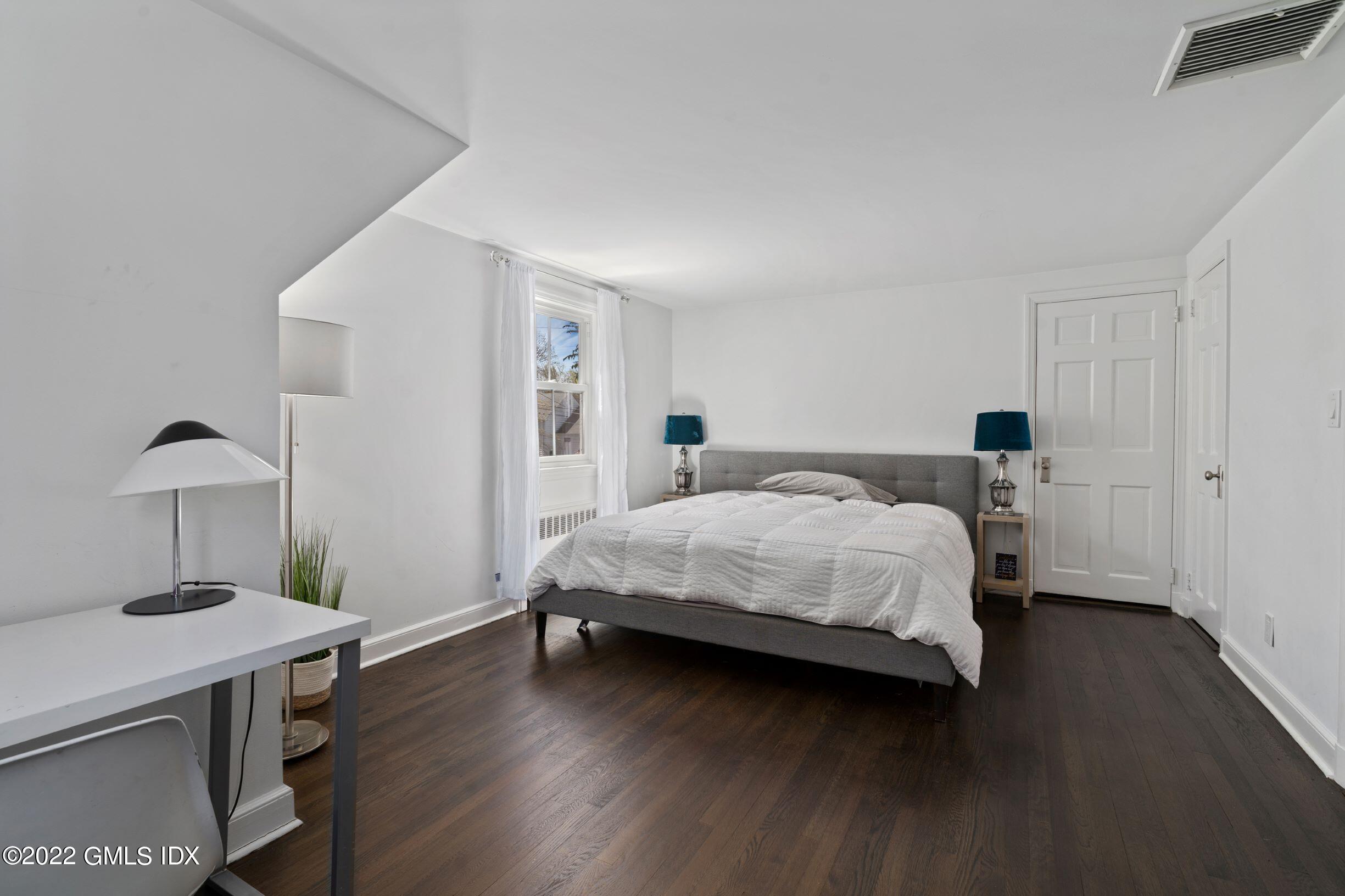 23 Manor Road Old Greenwich, CT 06870 - Photo 13 of 25 a bedroom with a bed and a table