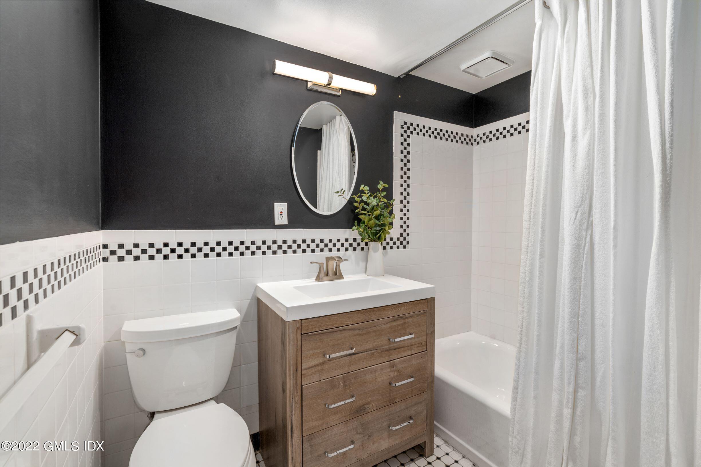 23 Manor Road Old Greenwich, CT 06870 - Photo 19 of 25 a bathroom with a toilet a sink and a mirror
