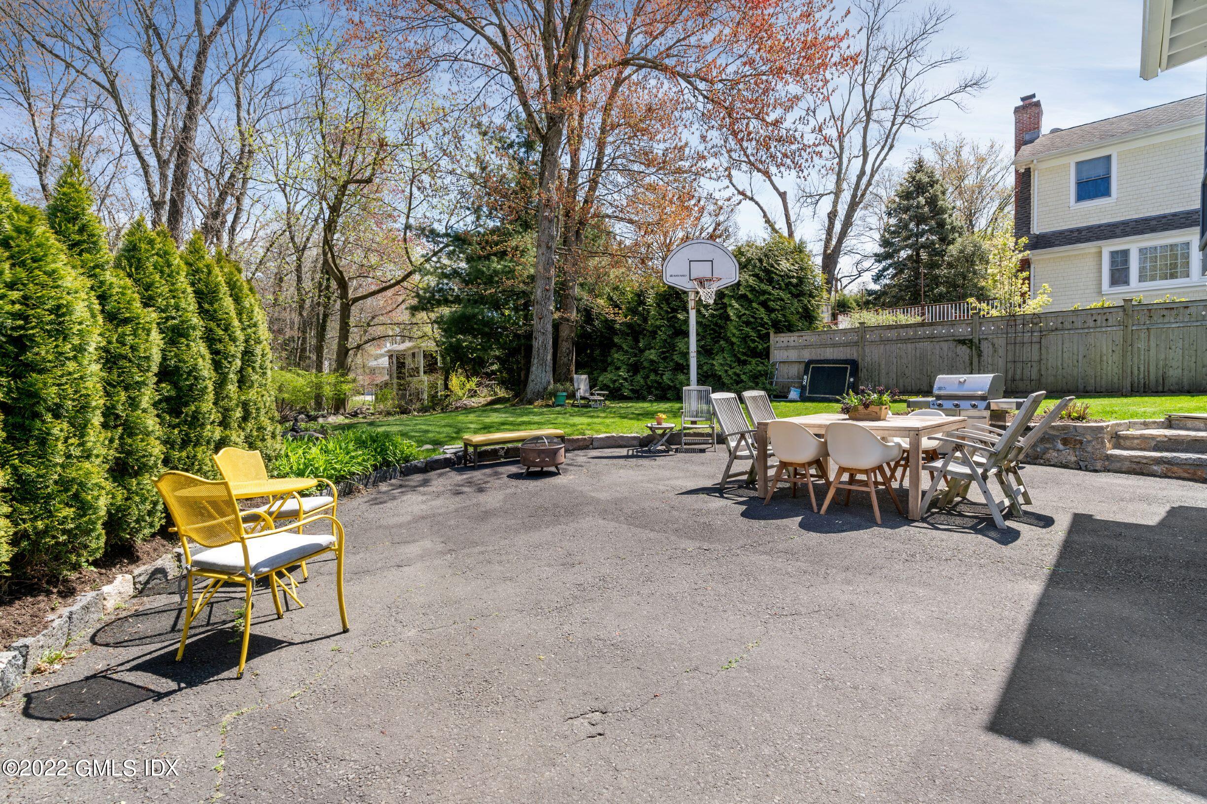 23 Manor Road Old Greenwich, CT 06870 - Photo 23 of 25 a view of a chairs and tables in the back yard of the house