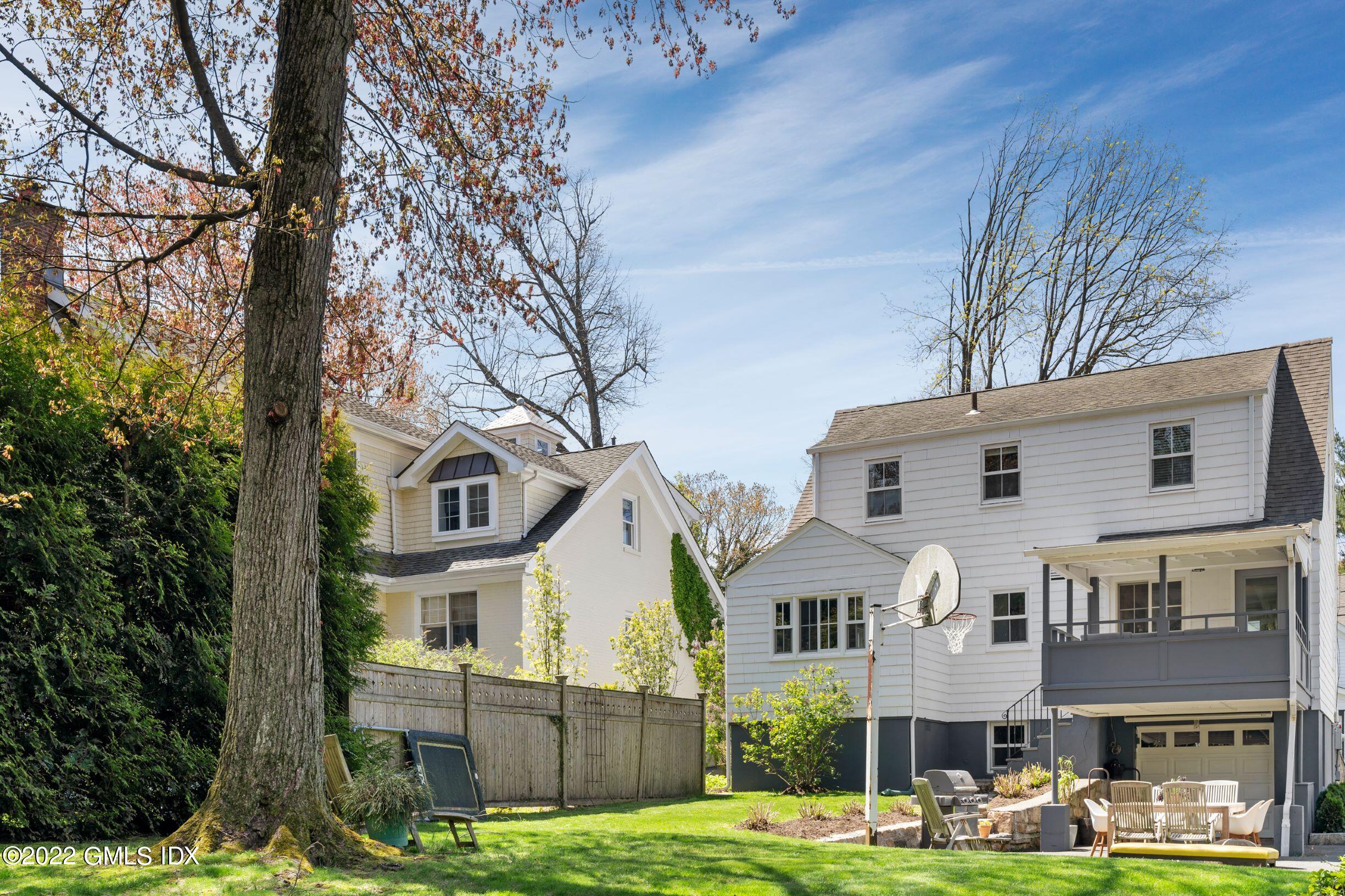 23 Manor Road Old Greenwich, CT 06870 - Photo 24 of 25 a front view of residential houses with yard and trees around