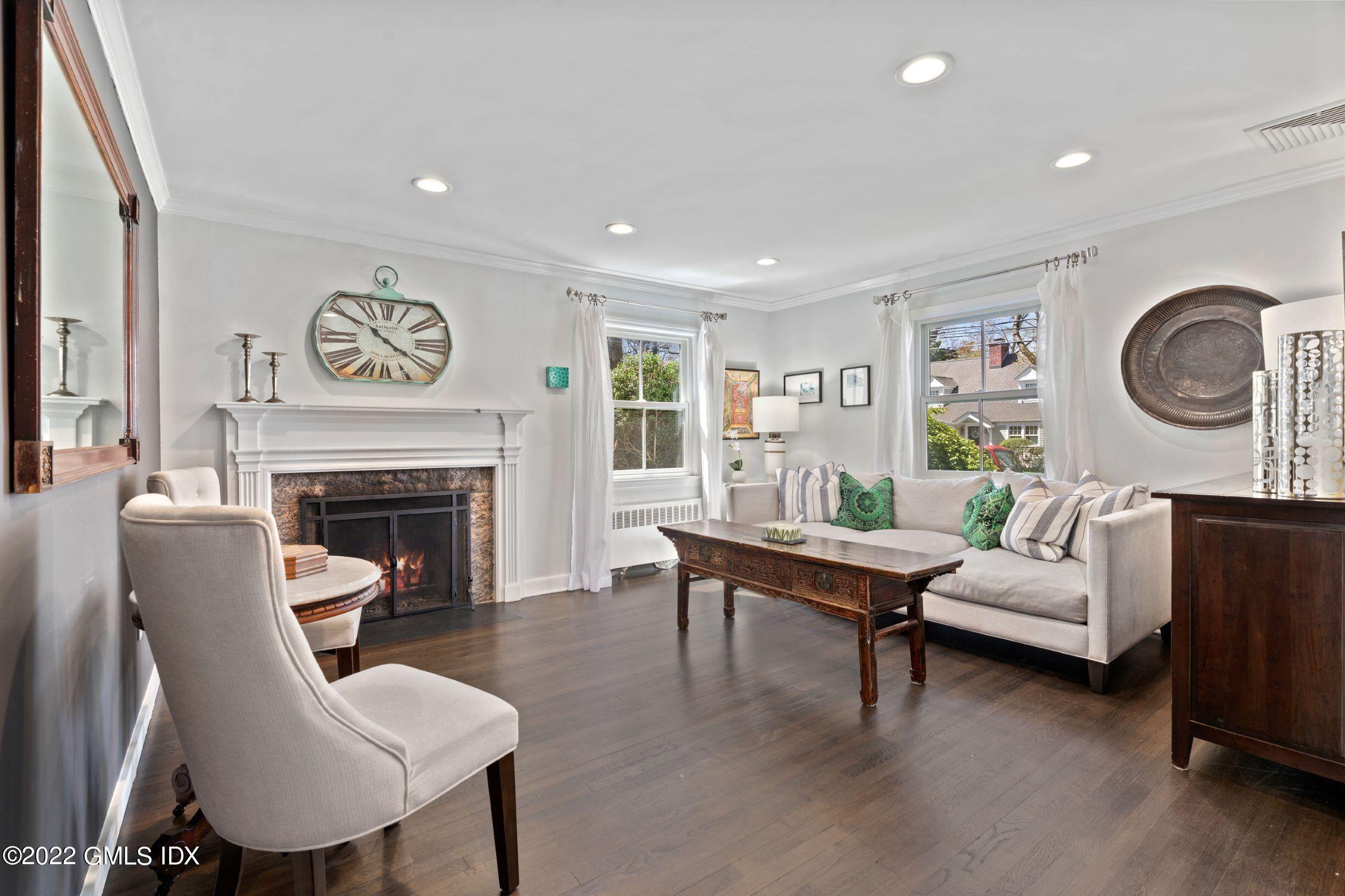 23 Manor Road Old Greenwich, CT 06870 - Photo 3 of 25 a living room with furniture and a fireplace