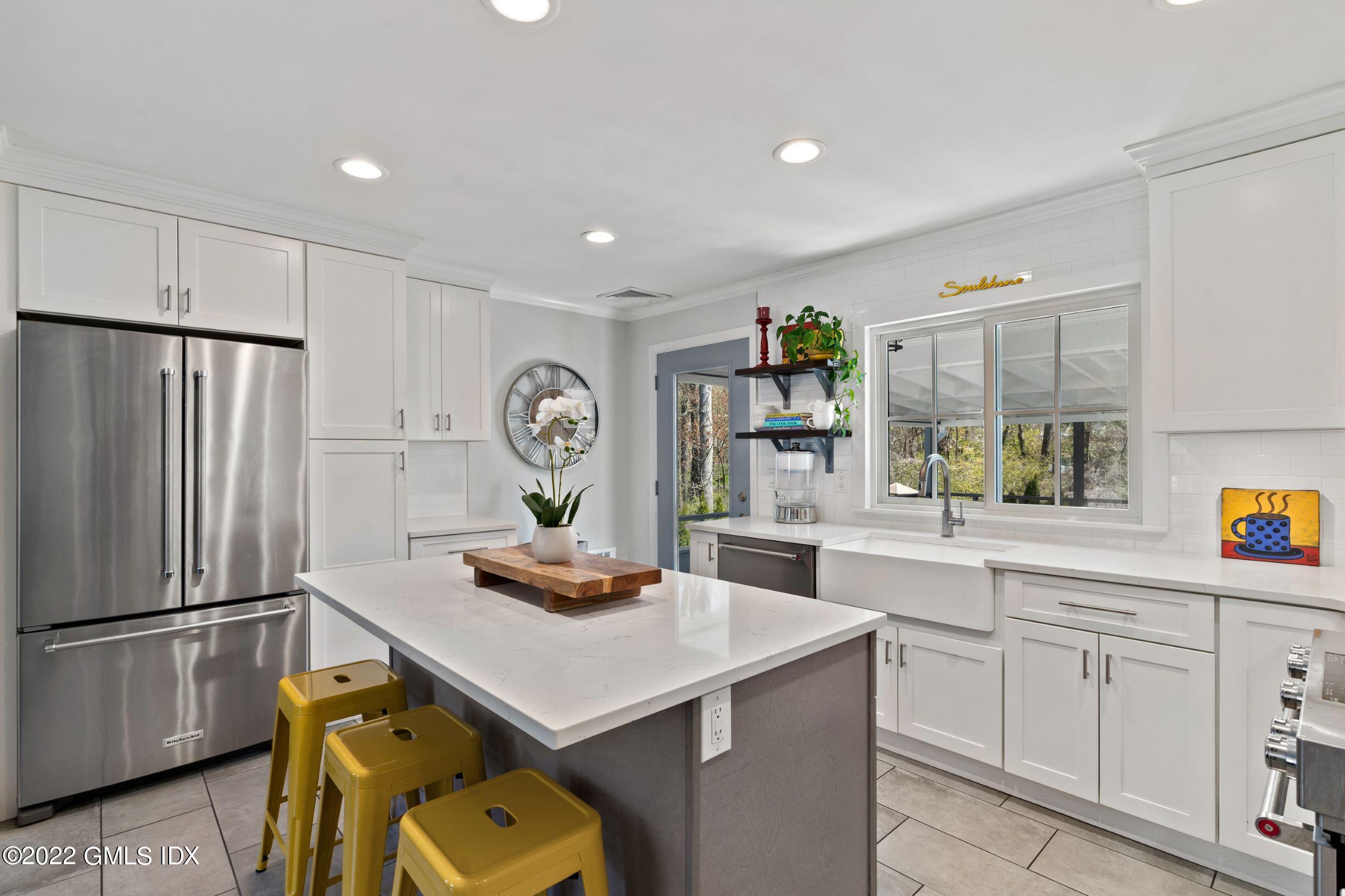 23 Manor Road Old Greenwich, CT 06870 - Photo 6 of 25 a kitchen with a refrigerator a sink and cabinets