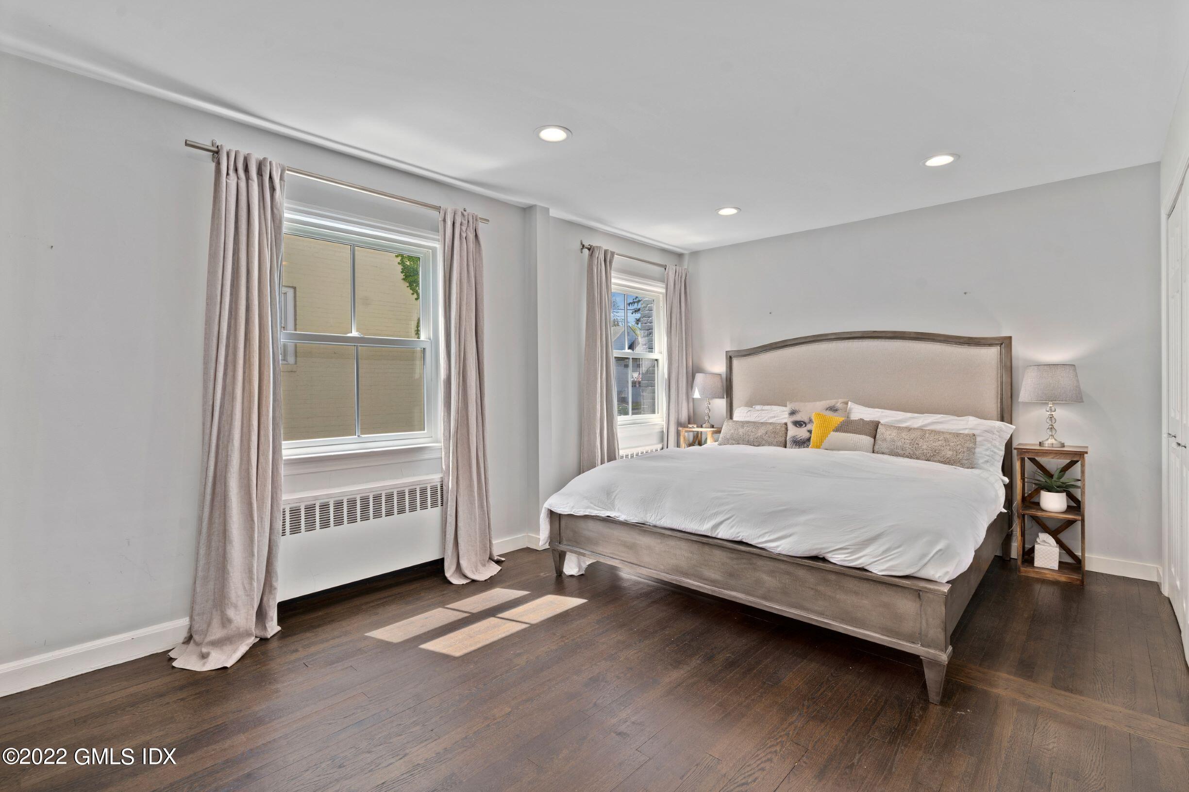 23 Manor Road Old Greenwich, CT 06870 - Photo 9 of 25 a bedroom with a bed and wooden floor