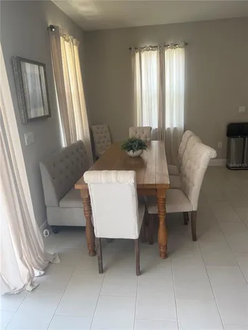 a kitchen with kitchen island granite countertop a stove a sink a microwave and a refrigerator