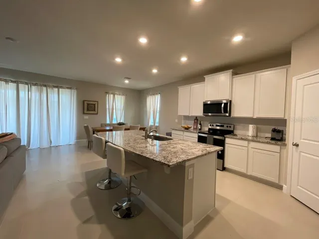 a refrigerator freezer sitting inside of a kitchen